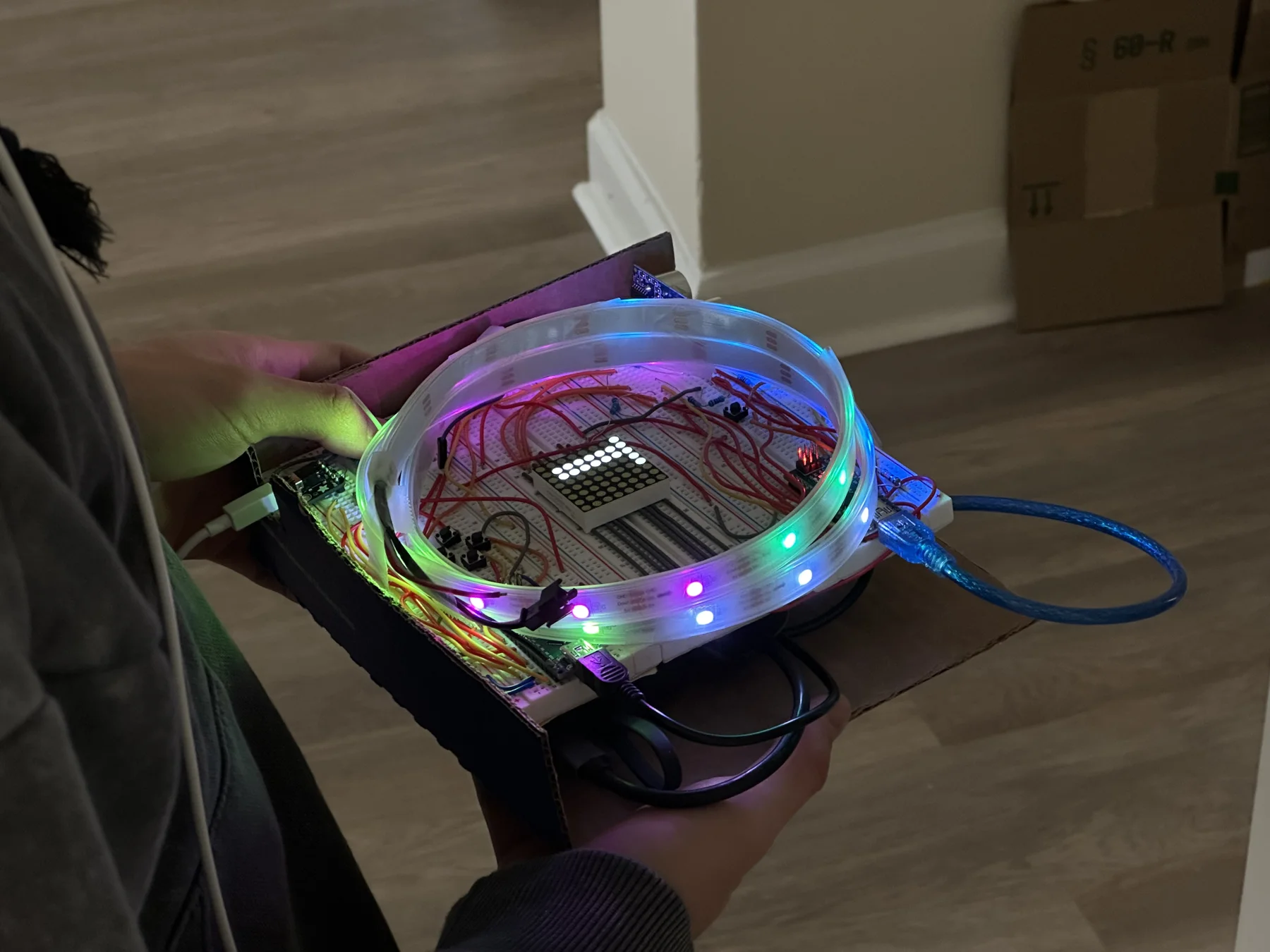 The real handmade station: a glowing translucent loop around breadboards, exposed wires and the LED matrix.